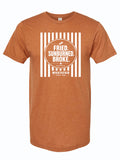 A heathered orange short-sleeve t-shirt with a white graphic print on the front. The graphic features vertical stripes, a circle, and the text 'FRIED. SUNBURNED. BROKE.'